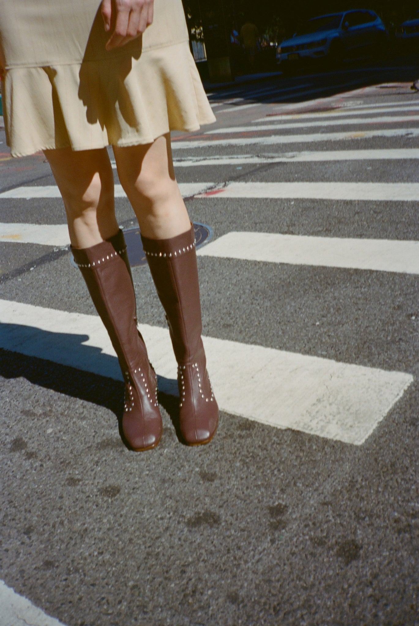 Brown knee-high boots with studs