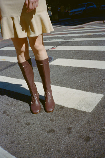 Brown knee-high boots with studs